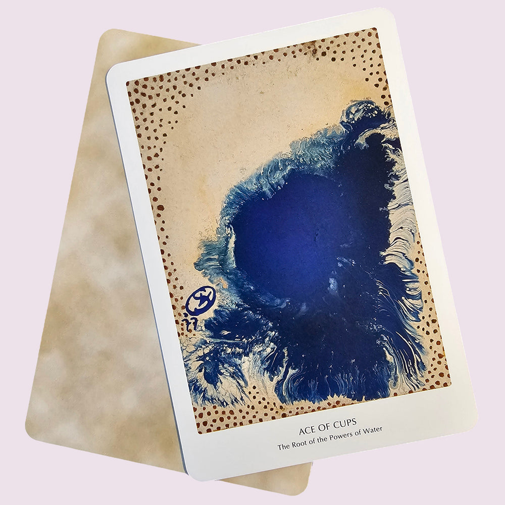 Card with a blue wave design on a textured card against a light pink background