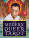 Cover of The Modern Queer Tarot hardcover book, featuring illustrated artwork in rich jewel tones with mirrored imagery and the title displayed prominently.