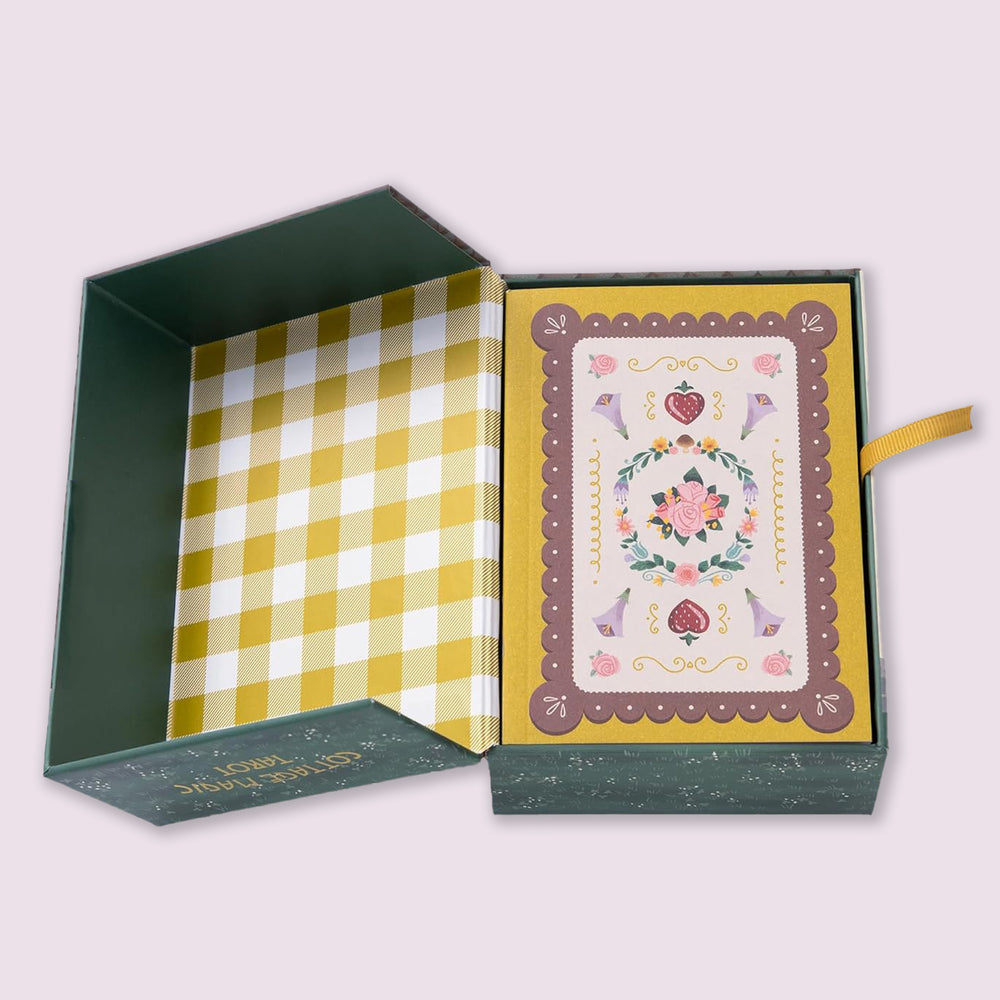 Cottage Magic Tarot open box displaying patterned interior, ribbon pull, and card deck nestled inside