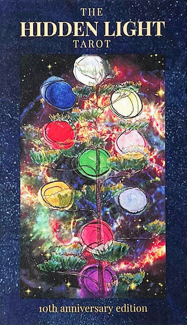 The Hidden Light Tarot card deck, 10th anniversary edition, featuring a dark blue textured cover with gold lettering and a central colorful illustration of a tree of life set against a cosmic nebula background.