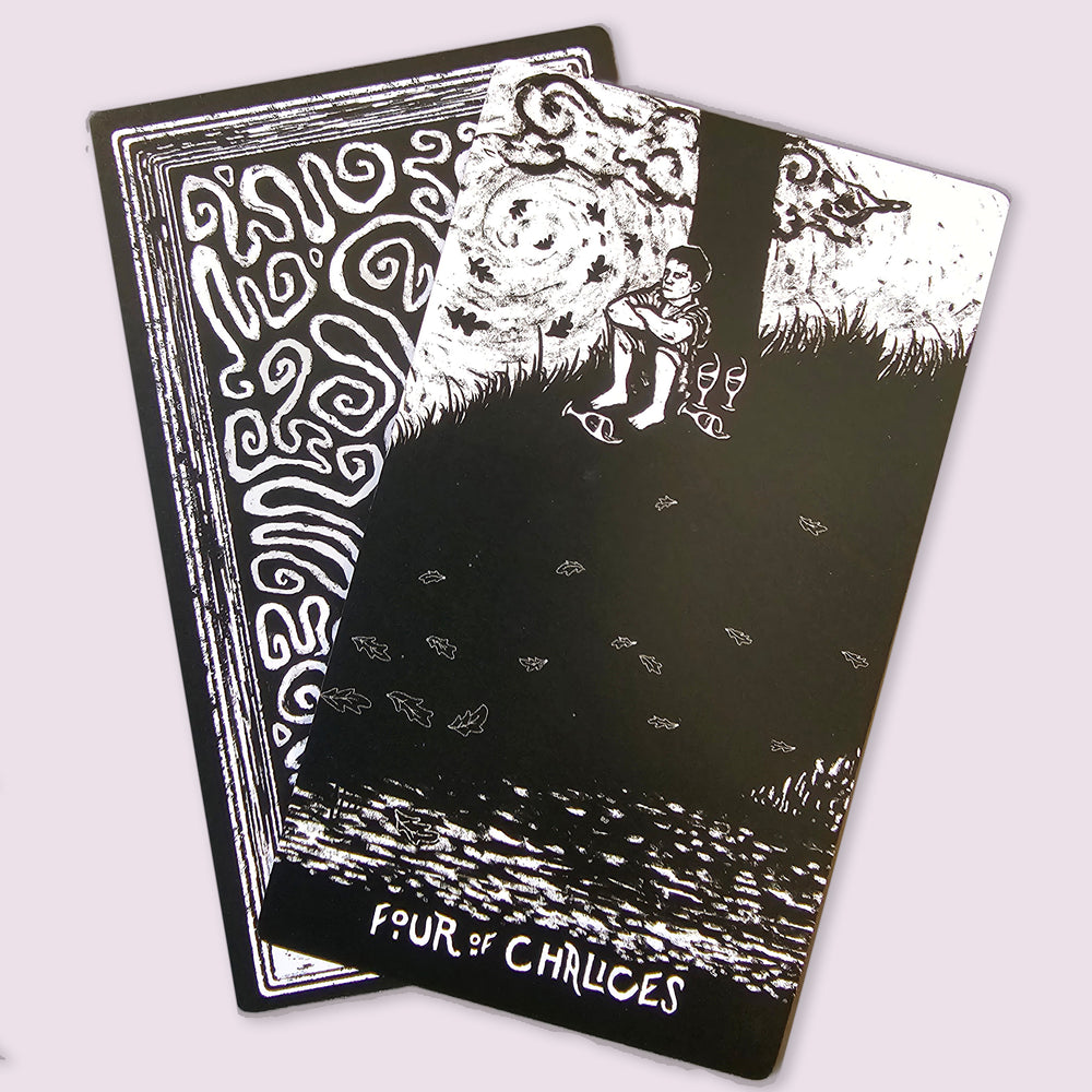 Night Visions Tarot Four of Chalices card depicting a solitary figure beneath a swirling sky in black and white artwork