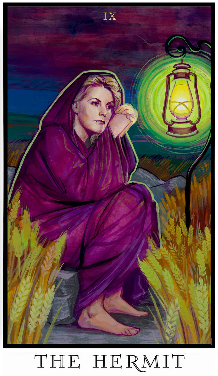 The Hermit tarot card from The Modern Queer Tarot showing Greta Garbo wrapped in deep violet tones, holding a lantern in a field at dusk, symbolizing solitude, reflection, and inner truth.