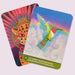Tz'unun (Hummingbird), Divine Messenger of Joy and Resilience card from The Mayan Oracle featuring a radiant hummingbird flying through clouds beneath a rainbow.
