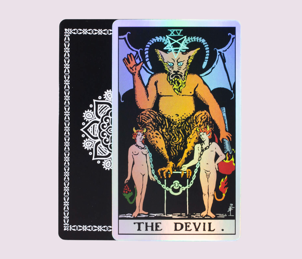 The Devil card from the Holo Tarot, presenting traditional Rider–Waite–Smith imagery with bold colors and a striking holographic foil finish.