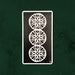 Three of Coins (Deux de Deniers) card from the Lux Tarot, featuring three circular coin symbols in UUSI's hand-carved linocut style.